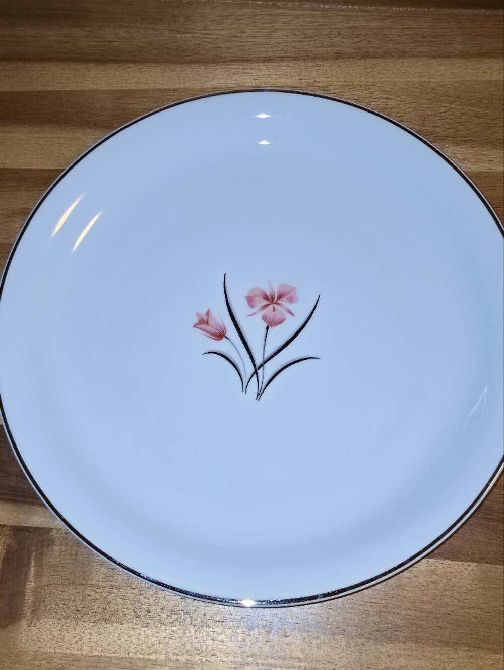 Elegant White Dinner Plate with Pink Floral Accent and Black Trim